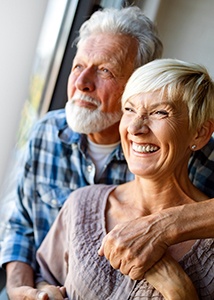 Older couple with dental implants in Jonesboro smiling inside