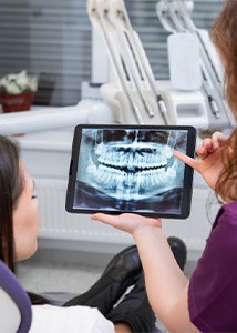 Dentist consulting with patient about her tooth extraction