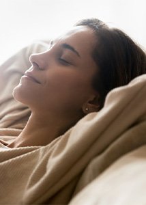 Woman relaxing on her couch now that her toothache is gone