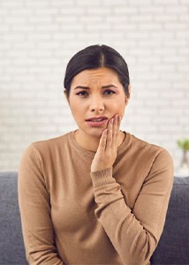 Woman rubbing her toothache