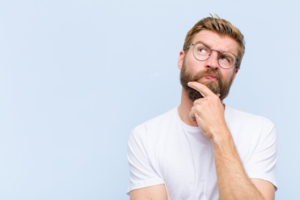 Man looking upwards in a questioning pose